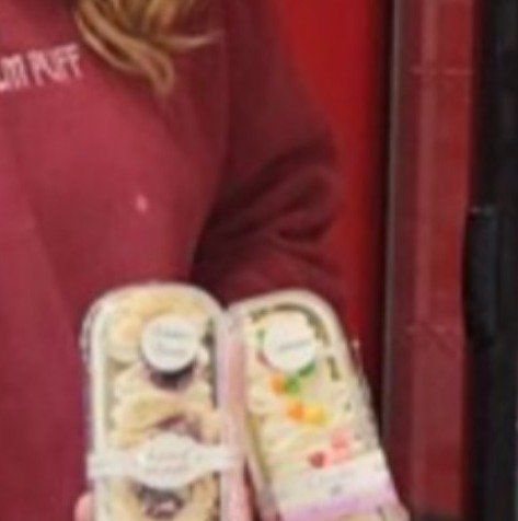 Two packages of decorated square mini cakes