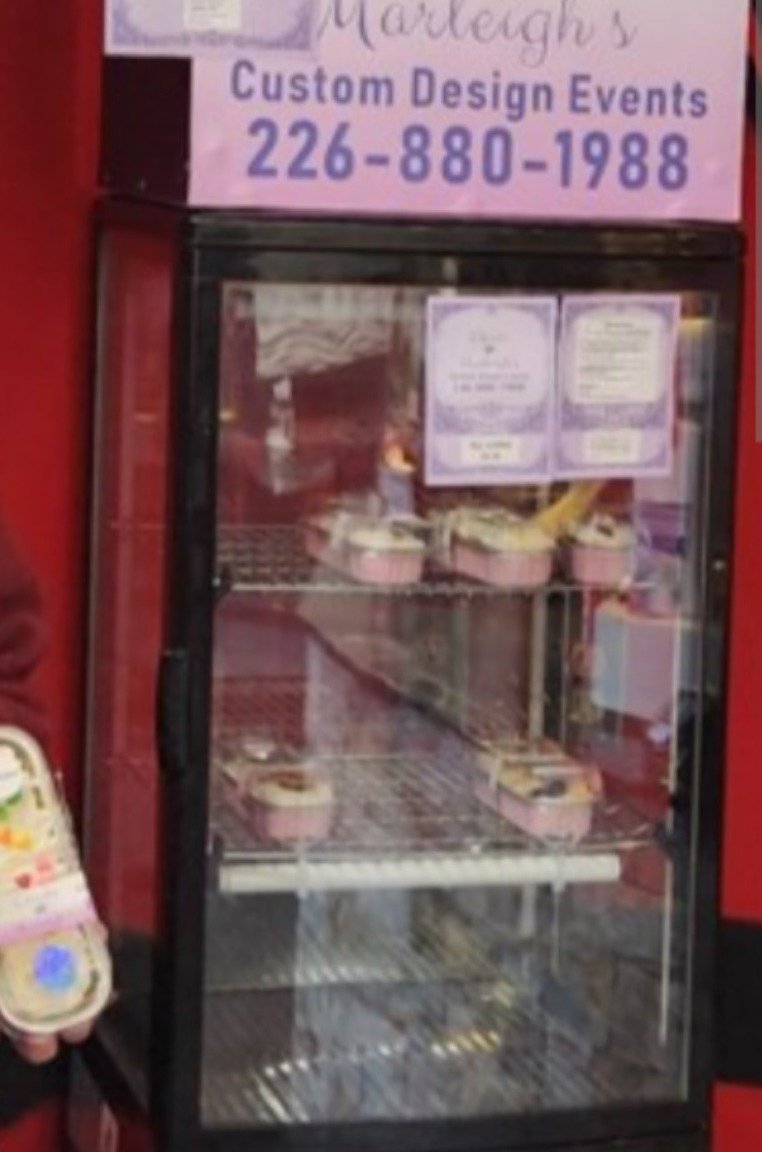 A refrigerated display case containing packaged mini cakes