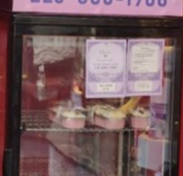 Mini cakes arranged inside a commercial display case